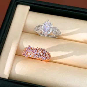 Detailed macro view of two ornate palace style zirconia rings in a jewelry box