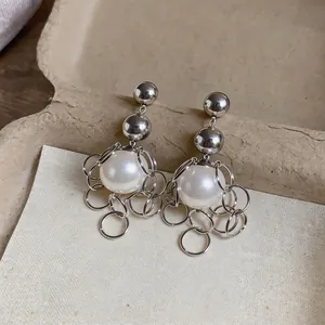 Detailed view of French vintage silver ring tassel stud earrings with large white pearls