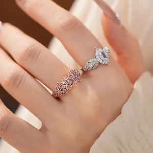 Close-up of elegant palace style zircon rings on finger with pink and purple stones