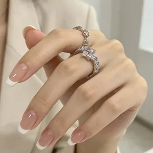 Primo piano dettagliato di un elegante anello in zircone su una mano con French manicure