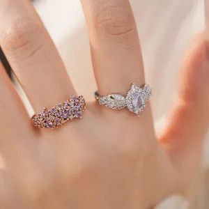 Exquisite close-up detail of silver and rose gold rings set with purple zirconia stones