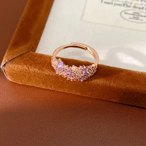 Detailed view of rose gold adjustable ring with sparkling purple zirconia stones