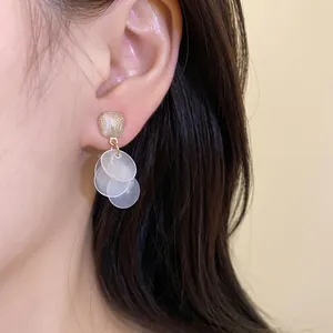 Elegant cat-eye stone stud earrings with translucent disc tassels on silver needles.