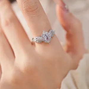 Detailed view of an elegant oval pink zirconia ring with intricate silver-plated vintage design