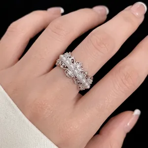 Elegant silver hollow lace ring with dainty pearls and zircons shown on index finger