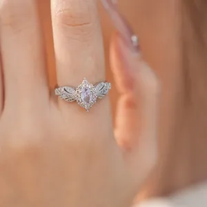 Detail view of a silver vintage palace style ring featuring an oval pink zircon stone