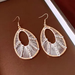 Elegant gold-tone hollow teardrop dangle earrings with sparkling rhinestones and woven detail