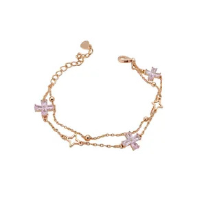 Elegant double-layer bracelet with pink zircon flowers and star charms in rose gold.