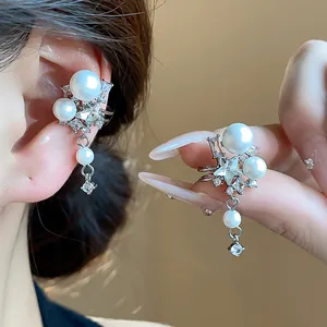 Close-up detail of stylish Korean-style zircon star and pearl ear cuff earrings for women
