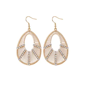 Elegant gold-tone teardrop earrings featuring sparkling rhinestones and fine thread wrapping