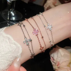 Detail of elegant double-layered clover bracelets featuring sparkling cubic zirconia stones