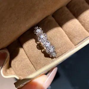 Close-up of a minimalist silver open ring with hollow circles and sparkling zircons