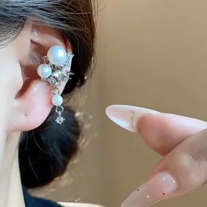 Elegant close-up shot of a star zircon and white pearl ear cuff earring worn on a model's ear