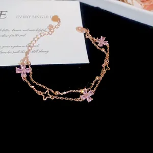 Rose gold double-layer bracelet featuring pink zircon four-leaf flower charms and stars.
