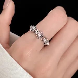 Close-up detail view of elegant silver hollow round ring with zircons on model's finger