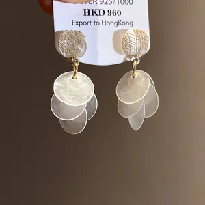 Elegant cat's eye stud earrings with translucent tiered disc tassels in a warm setting