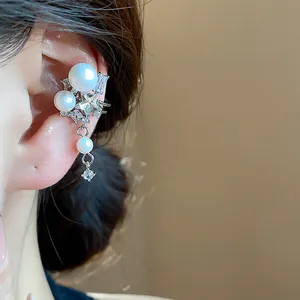 Elegant ear cuff with white pearls and sparkling zircon stars on ear.