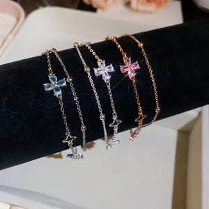 Close-up of double-layer chain bracelets with pink and blue flower zircon charms