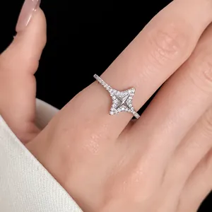 Elegant silver starburst open ring with pavé zircons shown in detail on finger.