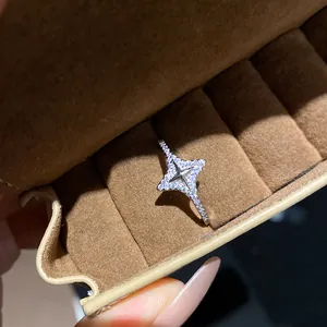 Close-up of sparkling star-shaped silver ring with micro-pave zirconia in a box