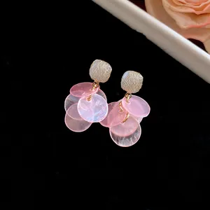 Detailed view of elegant pink cat's eye petal tassel earrings with golden wire wrapping