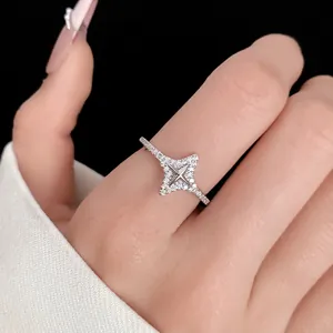 Macro view of an elegant silver four-pointed star ring with clear zirconia pavé