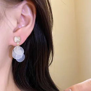 Detailed view of elegant cat's eye tassel earrings with translucent white discs