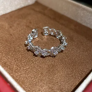 Detail view showing a sparkling zircon hollow open ring inside a luxury velvet jewelry box