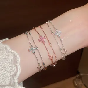 Close-up of layered floral zircon bracelets with elegant double-chain design.