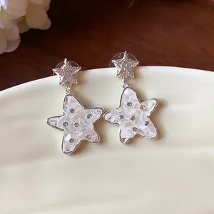 Elegant silver star earrings with white mother-of-pearl inlay and sparkling rhinestones