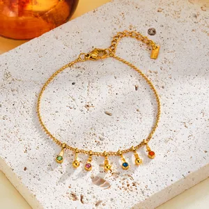 Detailed view of gold stainless steel bracelet featuring multi-color zircon charms