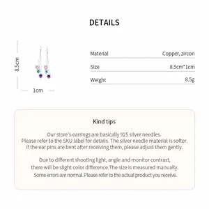 Detailed view of long tassel earrings with multi-colored heart-shaped zircon pendants.
