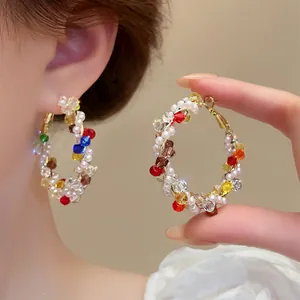 Stylish colorful beaded twisted hoop earrings featuring multi-color gems and white pearls