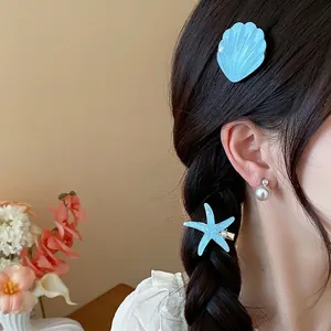 Resin starfish and shell hair clips for seaside vacation on Asian model