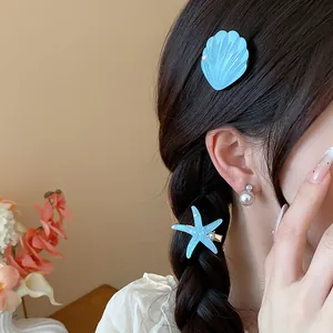Detailed view of seaside style resin shell and starfish hair clips on a braided hairstyle