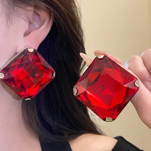 Detail view of fashion oversized square red crystal stud earrings with silver needles