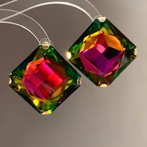 Detailed macro view of vibrant multi-colored faceted rhombus crystal earrings
