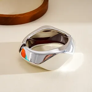 Macro view of silver chunky irregular geometric resin bangle with a hinge closure detail