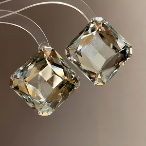 Macro view of faceted square gray crystals on elegant and stylish designer stud earrings