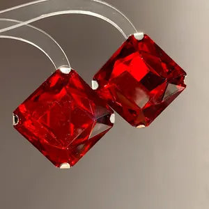 Detailed macro view of square red gemstone stud earrings with elegant silver prong settings