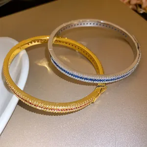 Close-up of gold and silver vintage bangles with micro-pave zircons and snap closure.