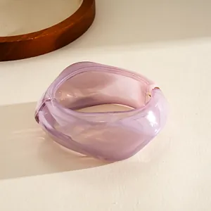 Macro detail of a purple irregular geometric resin bangle with smooth translucent finish