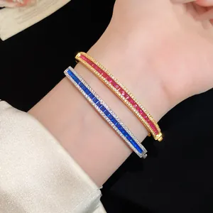 Detail of vintage court style zircon bracelets in gold red and silver blue colors