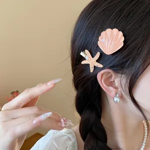 Macro detail of elegant resin starfish and seashell hair clips worn on a braided hairstyle