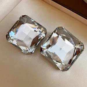 Macro view of square clear crystal stud earrings with elegant multifaceted facets