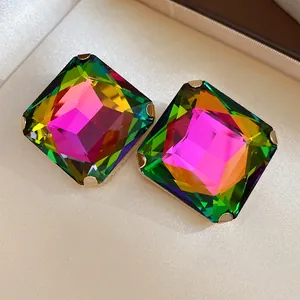 Detailed view of square stud earrings with faceted iridescent rainbow stones