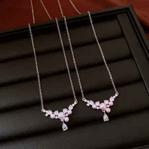 Detailed close-up of delicate zircon waterdrop pearl necklaces in white and pink variants