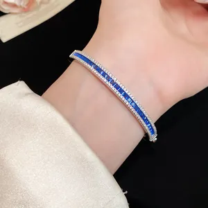 Detailed close-up showing the blue baguette-cut zircon setting on a silver bangle.