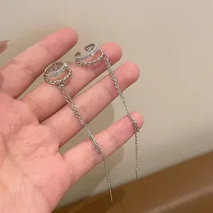 Macro view of zircon double-layer ear clips with elegant long silver chain tassels