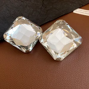 Macro view of clear square faceted crystal stud earrings featuring elegant metal claw settings